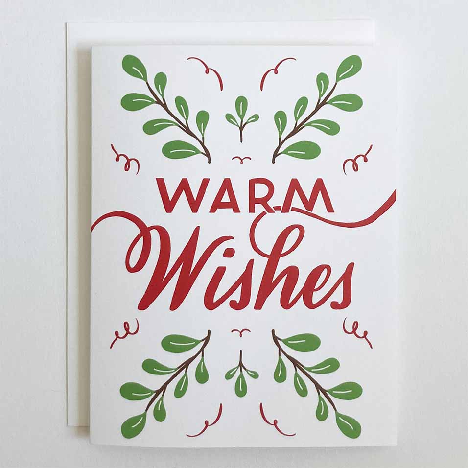 Greeting card with 'Warm Wishes' text and green leaf designs on a white background