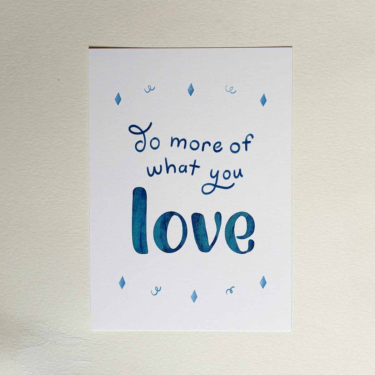 Art Print with the saying Do More of What you Love on a white wall