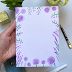 Hand holding Purple Flowers Notepad