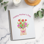 Mother's Day card with floral design on a marble surface with candles and eucalyptus leaves.