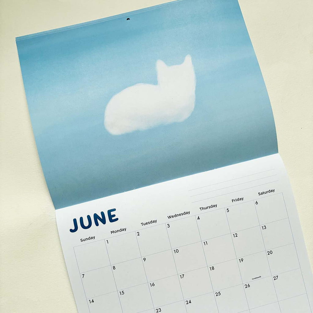 Calendar for June with a cloud-shaped cat on a blue background