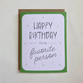 A greeting card with a minimalist design, featuring the 'Happy Birthday to my favorite person' on the front, with a Kraft envelope.