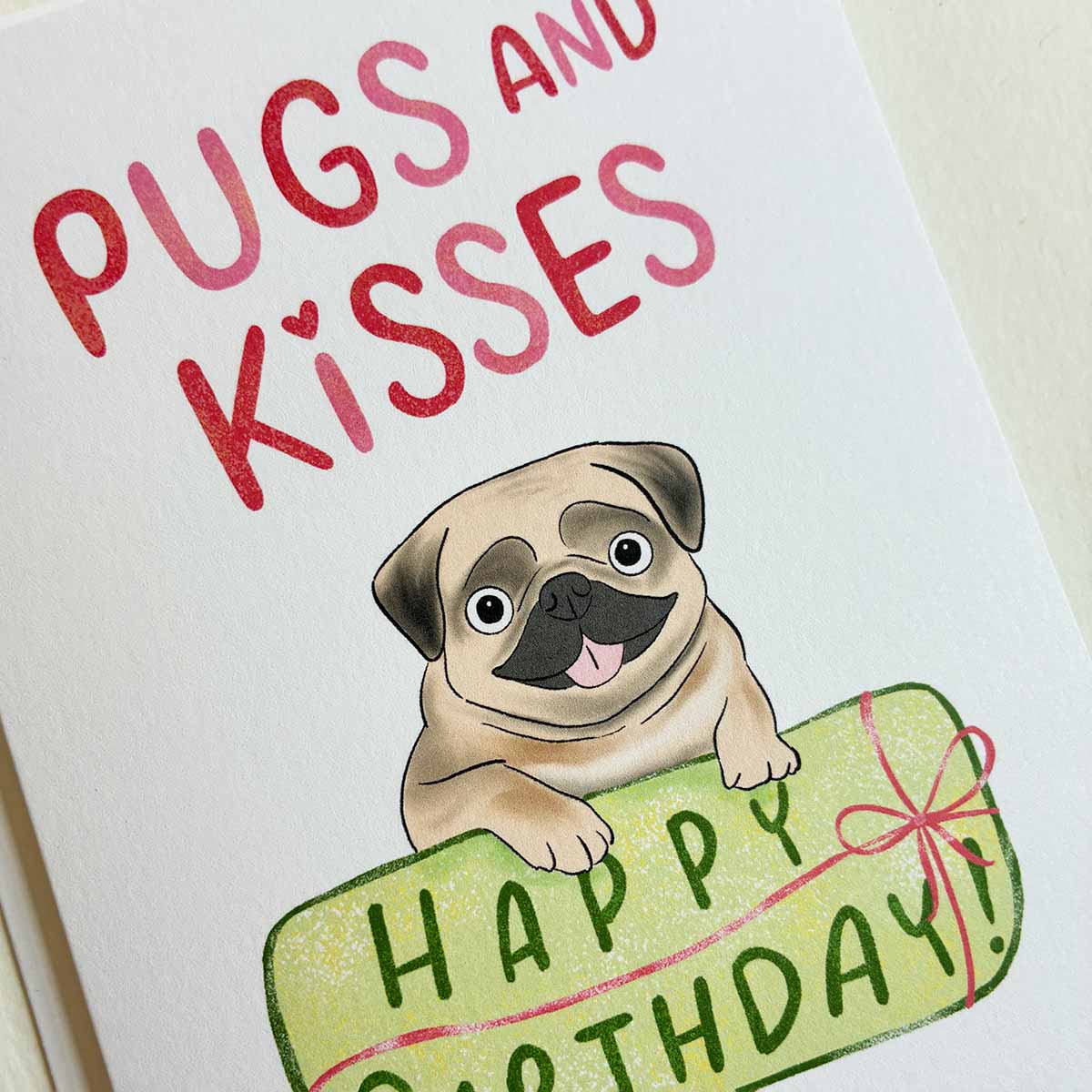 Card with a dog pug illustration and 'Pugs and Kisses Happy Birthday' text on a white background.