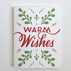 Greeting card with 'Warm Wishes' text and green leaf designs on a white background
